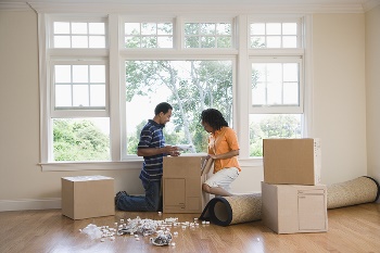 couple unpacking boxes at new house_small