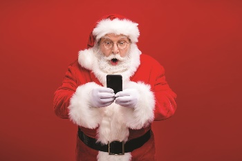 Santa holding cell phone with shocked look