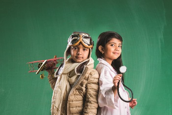 Boy and girl dressed up as a pilot and doctor