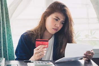 Woman looking over credit card statement
