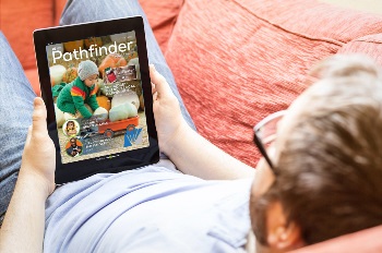 Guy on tablet reading Pathfinder Magazine
