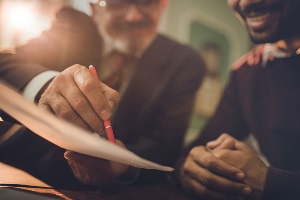 men signing documents