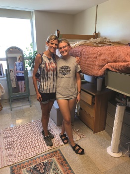 Mother and daughter standing in dorm room