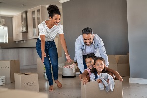 Mother and father pushing daughters in box