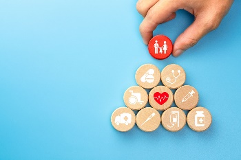 building blocks with healthcare icons and family on top