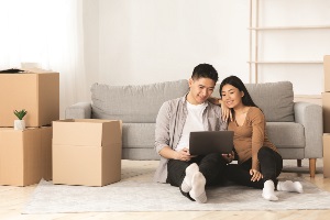 Asian couple sitting together looking at computer