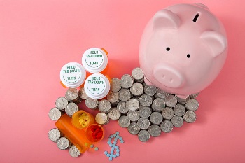 Piggy bank with change and prescription pill bottles