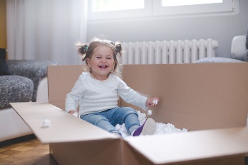 cute baby girl in moving box