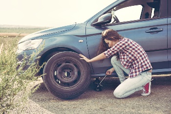 Woman changing tire