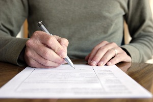 Man signing paper